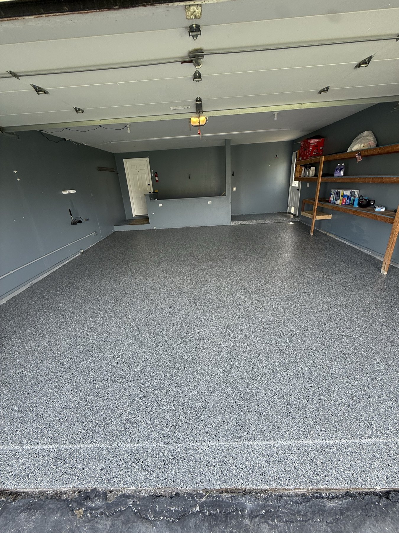 Completed two-car garage flake floor coating viewed from the open garage door